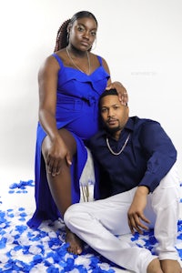 a man and woman posing for a photo in a blue dress