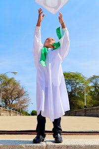 a boy in a graduation gown